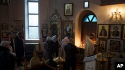Ukrainians attend a Christmas mass at an Orthodox Church in Bobrytsia outskirts of Kyiv, Dec. 25, 2022. 