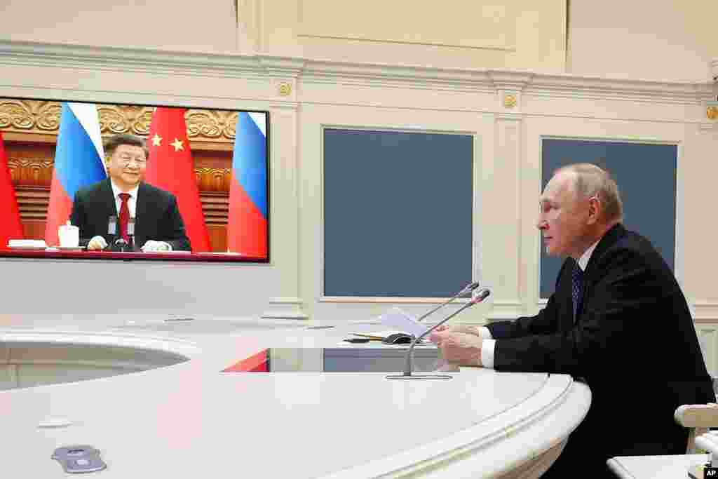 Russian President Vladimir Putin speaks with Chinese President Xi Jinping over a video conference at the Kremlin in Moscow, Russia.