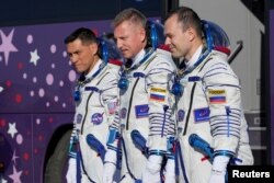 FILE - Frank Rubio, Roscosmos cosmonauts Sergey Prokopyev and Dmitri Petelin, crew members of the mission to the International Space Station, ISS, walk to the rocket prior to the launch of Soyuz MS-22 at the Baikonur cosmodrome, Kazakhstan, Sept. 21, 2022.