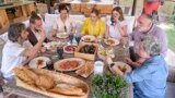 FILE - Diego Guerrero, from left, Carlos Sanchez, Mila, Ines Andres, Carlota Andres, Jose Andres and Pepa Muñoz enjoy a meal in a scene from the Discovery + television series "Jose Andres and Family in Spain." (Xaume Olleros/Discovery via AP)