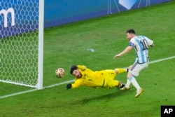 FILE - Argentina's Lionel Messi scores his side's 3rd goal during the World Cup final soccer match between Argentina and France at the Lusail Stadium in Lusail, Qatar, Sunday, Dec. 18, 2022. (AP Photo/Hassan Ammar)