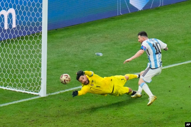 Lionel Messi scores the 3rd goal for Argentina during the World Cup final soccer match between Argentina and France at the Lusail Stadium in Lusail, Qatar, Sunday, Dec. 18, 2022. (AP Photo/Hassan Ammar)