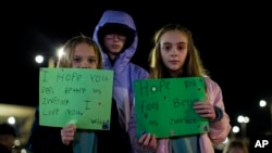 Willow Crawford, left, and her older sister Ava, right, join friend Kaylynn Vestre, center, in expressing their support for Richneck Elementary School first-grade teacher Abby Zwerner on Jan. 9, 2023. (AP Photo/John C. Clark)
