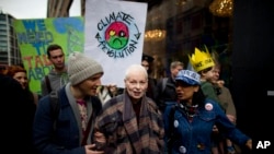 FILE - British Fashion designer Vivienne Westwood, center, takes part in an environmental protest against the practice of fracking, in London on March 19, 2014.