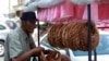 A street vendor arranges 'Kaak' a Lebanese street bread in the southern Lebanese city of Sidon, Sept. 6, 2022. 