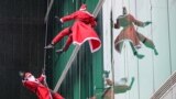 Climbers dressed as Santa Claus climb the building of the paediatric clinic of the Ljubljana University Medical Centre in Ljubljana, Slovenia, Dec. 19, 2022.