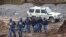South African police investigate at the scene where more than 20 bodies, suspected of being illegal miners, were found near an active mine in Krugersdorp, South Africa, Nov. 3, 2022.