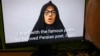 A person on Nov. 28, 2022 watches Farideh Moradkhani, the niece of Supreme Leader Ali Khamenei, speaking in a video posted on YouTube. 