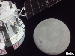 A portion of the far side of the Moon looms large just beyond the Orion spacecraft in this image taken Monday, Nov. 21