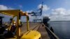 FILE - A Sri Lankan port worker stands on jetty at the Chinese-run International Port in Hambantota, Sri Lanka, Aug. 16, 2022. 