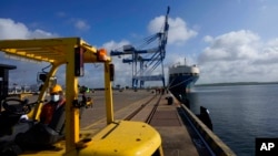 FILE - A Sri Lankan port worker stands on jetty at the Chinese-run International Port in Hambantota, Sri Lanka, Aug. 16, 2022. 