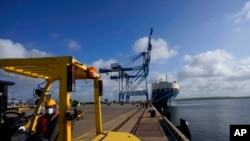 FILE - A Sri Lankan port worker stands on jetty at the Chinese-run International Port in Hambantota, Sri Lanka, Aug. 16, 2022.