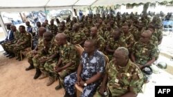 Soldiers listen to Togolese President and then-presidential candidate of the ruling Union for the Republic (UNIR) party during his visit to a military facility at Namoundjoga village in northern Togo, on February 17, 2020.