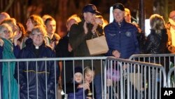 President Joe Biden stands with his son Hunter Biden and other family members during the annual Christmas Tree Lighting ceremony in Nantucket, Mass., Friday, Nov. 25, 2022.