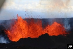 This aerial image courtesy of Hawaii Dept. of Land and Natural Resources shows lava flows on Mauna Loa, the world's largest active volcano, on Wednesday, Nov. 30, 2022, near Hilo, Hawaii. (Hawaii Dept. of Land and Natural Resources via AP)