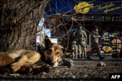 Ukrainian soldiers buy food in Kostyantynivka, eastern Ukraine on Dec. 1, 2022.