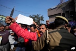 Activists of right-wing Hindu group Rashtriya Bajrang Dal, reacting to the militant attack in the southern Rajouri district of Indian-controlled Kashmir, shout slogans during a protest in Jammu, Jan. 2, 2023.