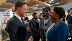 Dutch Prime Minister Mark Rutte talks to invited guests after apologizing on behalf of his government for the Netherlands' historical role in slavery and the slave trade at the National Archives in The Hague, Dec. 19, 2022.
