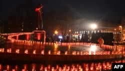 Local residents light candles to commemorate the victims of the 1932-33 Holodomor, Ukrainian for "death by starvation," in Lviv, Nov. 26, 2022, amid the Russian invasion of Ukraine.
