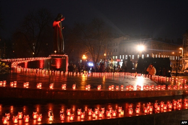 Local residents light candles to commemorate the victims of the 1932-33 Holodomor, Ukrainian for 'death by starvation,' in Lviv, Nov. 26, 2022, amid the Russian invasion of Ukraine.
