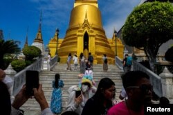 FILE - Tourists visit the Grand Palace, one of the top tourist attraction spots, after China reopens its borders amid the COVID-19 pandemic, in Bangkok, Thailand, Jan. 7, 2023.