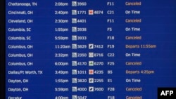 An electronic board showing flight delays and cancellations at United Airlines Terminal 1 at Chicago's O'Hare International Airport on December 22, 2022.