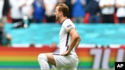 FILE - England's Harry Kane wears a rainbow armband prior to a Euro 2020 soccer championship match at Wembley Stadium. The captains of 7 European nations will not wear anti-discrimination armbands in World Cup games after threats from FIFA to show yellow cards to the players. 