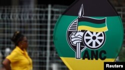 A delegate stands near a banner during the 55th National Conference of the ruling African National Congress (ANC) at the Nasrec Expo Centre in Johannesburg, South Africa, Dec. 18, 2022.