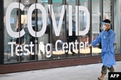 A health worker walks in front of a COVID-19 testing center at Incheon International Airport, west of Seoul, Jan. 3, 2023.