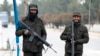 Taliban security personnel stand guard at a checkpoint along a street in Kabul on Jan. 10, 2023. 