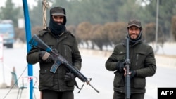 Taliban security personnel stand guard at a checkpoint along a street in Kabul on Jan. 10, 2023. 