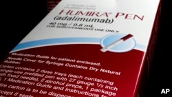 FILE - AbbVie's signature drug Humira is shown in this photo illustration, in Houston, Texas, July 18, 2014.