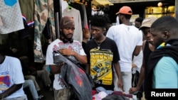 People shop second-hand clothes during a vintage gala event in Accra, Ghana, December 20, 2022.