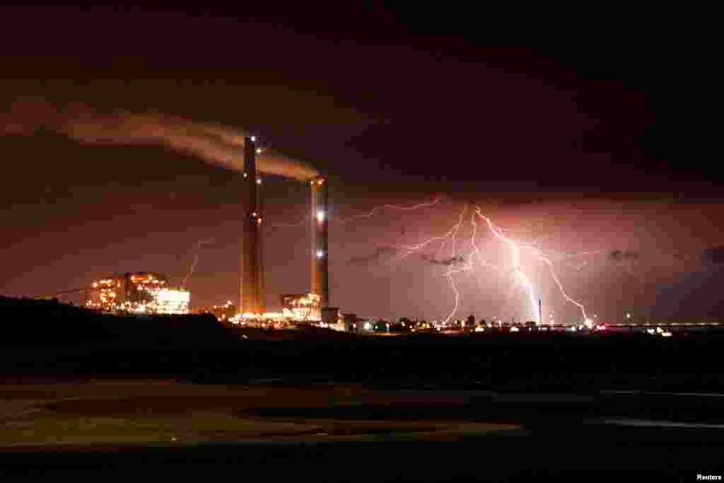 Rutenberg power station is seen as lightning strikes over the Mediterranean sea at the coastal city of Ashkelon, Israel.