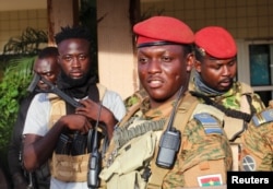 FILE - Burkina Faso's new military leader Ibrahim Traore is escorted by soldiers in Ouagadougou, Oct. 2, 2022.