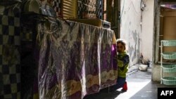 One of the children of Alia Abdel-Razak, a woman who was denied vital civil status documents, is pictured at her rundown home in the northern Iraqi city of Mosul December 11, 2022.
