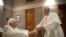 file: Pope Francis (RIGHT) greets Pope Emeritus Benedict XVI during a meeting following a consistory ceremony to install 13 new cardinals, at the Vatican, November 28, 2020. 