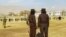 Taliban security personnel stand guard ahead of publicly flogging of women and men at a football stadium in Charikar city of Parwan province on December 8, 2022. 