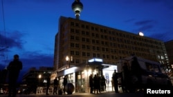 FILE - People walk past a police station in Berlin, Germany, Dec. 31, 2022. 