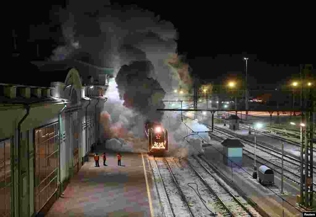 A steam train of Father Frost, the Russian equivalent of Santa Claus, and Snow Maiden, which travels all over the country ahead of the New Year and Christmas season, arrives at a railway station in Omsk, Russia, Nov. 27, 2022.