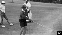 FILE - Kathy Whitworth blasts out of a sand trap on 18th green and then sinks a 6-foot putt to go into the lead of the Women Titleholders Golf Tournament at Augusta, Georgia, Nov. 25, 1966.