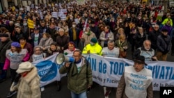 People march during a protest in support of public health care in Madrid, Spain, Jan. 15, 2023. 