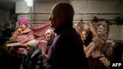 Worshippers pray during an Orthodox Christmas mass in a basement shelter in Chasiv Yar, Eastern Ukraine, on Jan. 7, 2023, amid the Russian invasion of Ukraine.