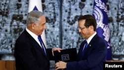 FILE - Israel President Isaac Herzog hands Benjamin Netanyahu the mandate to form a new government, at the President's residency in Jerusalem, Nov. 13, 2022. 