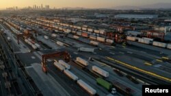 FILE - Gantry cranes, shipping containers, and freight railway trains are seen at the Union Pacific Los Angeles (UPLA) Intermodal Facility rail yard in Commerce, California, Sept. 15, 2022.