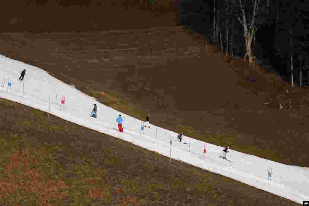 People skiing on a slope in Filzmoos south of Salzburg, Austria.
