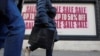 FILE - People walk along a shopping street in London, Britain, Dec. 26, 2022.