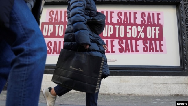 FILE - People walk along a shopping street in London, Britain, Dec. 26, 2022.