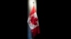 FILE - The Canadian flag displayed at the Embassy of Canada in Washington, June 20, 2019. Canada is is making it possible for the first time for spouses and working-age children of temporary foreign workers to work legally in the country themselves.
