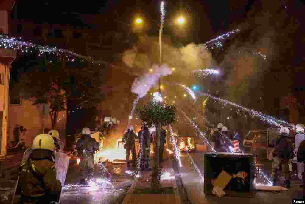 A firework explodes over riot police officers during clashes with demonstrators&nbsp;following an anniversary rally marking the 2008 police shooting of 15-year-old student Alexandros Grigoropoulos, in Thessaloniki, Greece, Dec. 6, 2022.